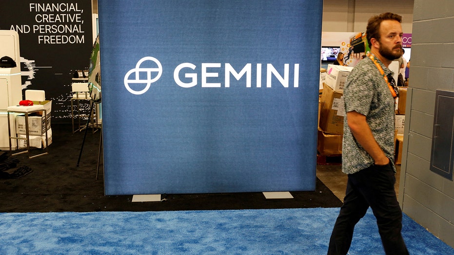 A man walks past the logo of Gemini Trust during the Bitcoin Conference 2022 in Miami Beach, Florida, on April 6, 2022.
